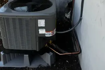 Professional AC maintenance technician performing system inspection