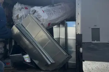 Professional commercial HVAC technician servicing rooftop unit