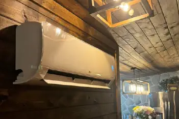 Professional HVAC technician working on air conditioning unit in Portsmouth