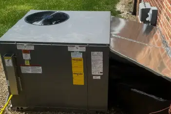 Professional technician performing package unit maintenance